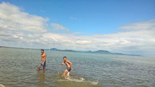 People on beach against sky