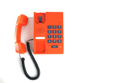 Close-up of telephone booth against white background