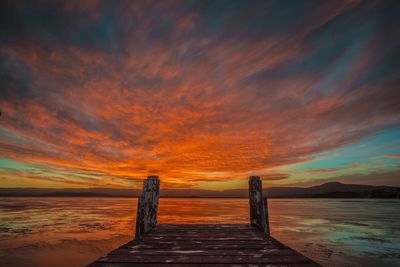 Scenic view of sea against dramatic sky during sunset