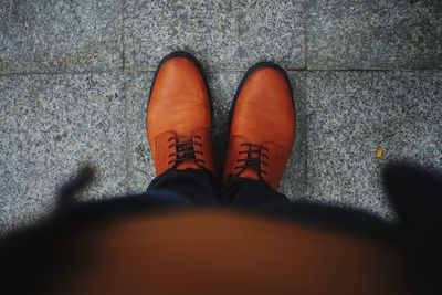 Low section of man with orange shoes