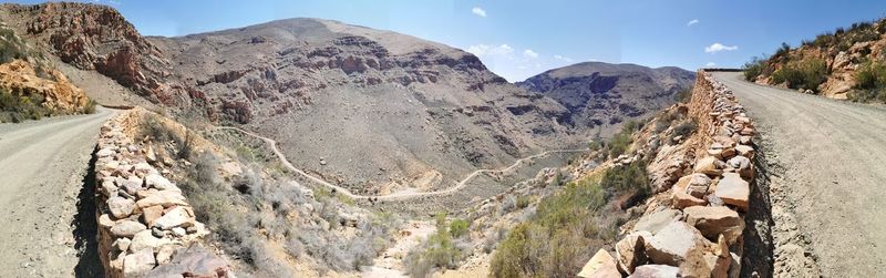 Panoramic view of road amidst mountains against sky