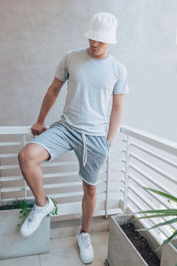 Portrait of young man standing on staircase