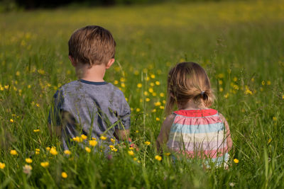 Rear view of girl standing on grass