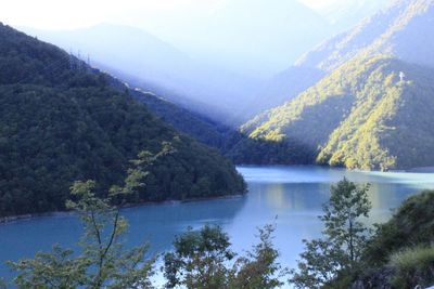 Scenic view of lake and mountains against sky