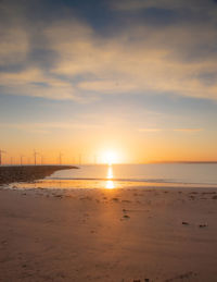 Scenic view of beach against sky during sunset