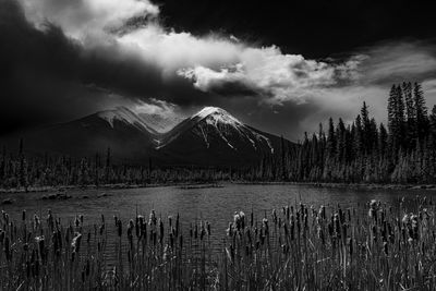 Storm clouds drift over the canadian rocky mountains at vermillion lakes near banff, alberta, canada