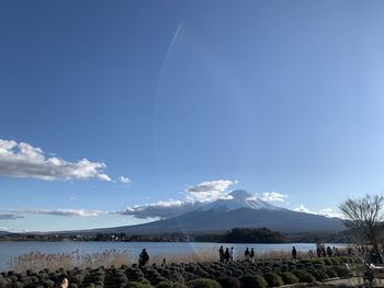 Scenic view of snowcapped mountains against blue sky