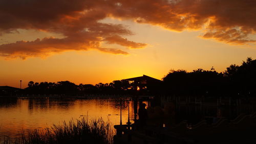 Scenic view of lake against orange sky