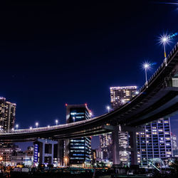 Low angle view of suspension bridge at night