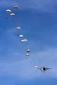 Low angle view of airshow against blue sky