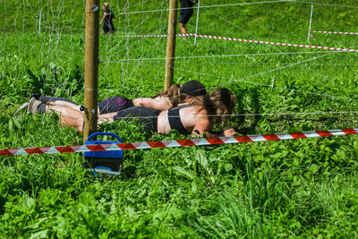 Woman lying on grassy field