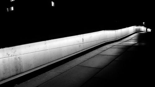 Illuminated railroad station platform at night