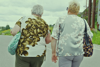 Rear view of women walking outdoors