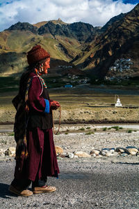 Full length of man with arms raised on mountain