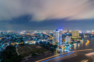 High angle view of illuminated buildings against sky at night