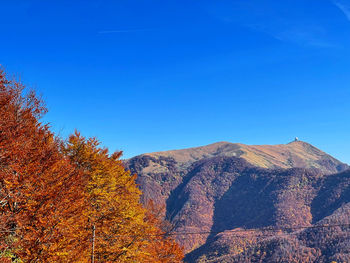 Scenic view of mountains against clear blue sky