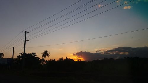 Silhouette trees against sky during sunset