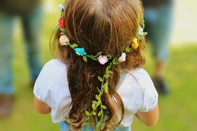 Rear view of flower garland in girl's hair