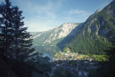 Scenic view of river and mountains against sky