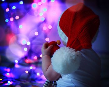 Close-up of hand holding illuminated christmas lights