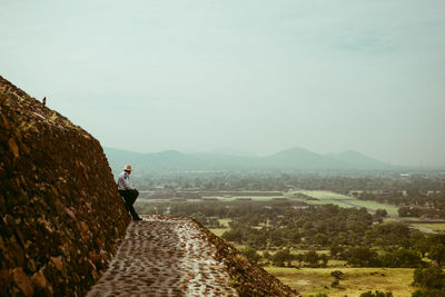 Man on mountain against sky