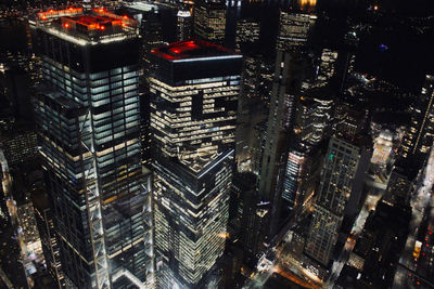 Aerial view of illuminated buildings in city at night