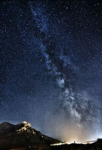 Scenic view of mountain against star field