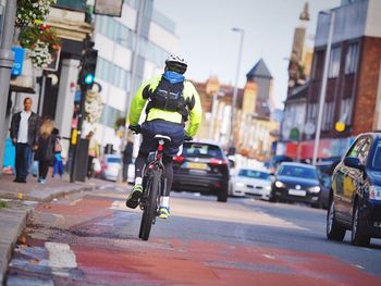 Man cycling on city street