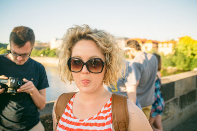 Portrait of young woman sticking out tongue