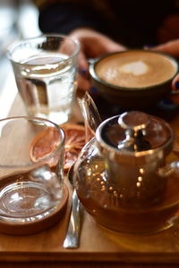 Moroccan tee and coffee on a wooden plate in a coffee shop with grape slice and books opened