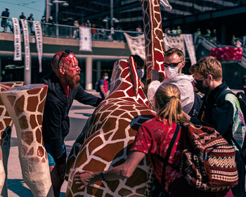 Rear view of people at market stall