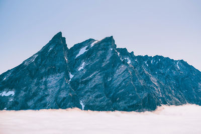 Scenic view of snowcapped mountains against clear blue sky