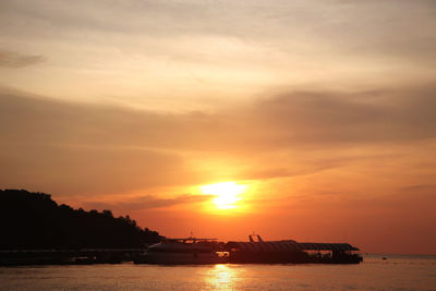 Scenic view of sea against romantic sky at sunset
