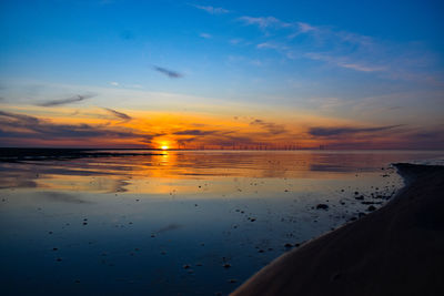 Scenic view of beach against sky during sunset