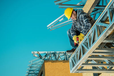 Low angle view of spiral staircase against clear blue sky