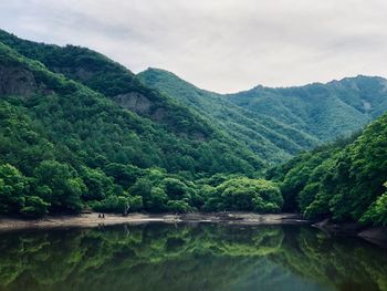 Scenic view of lake and mountains against sky