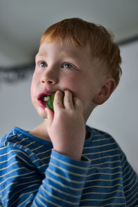 Close-up portrait of boy eating