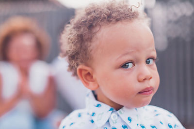 Mixed race baby boy with blue eyes looking at camera