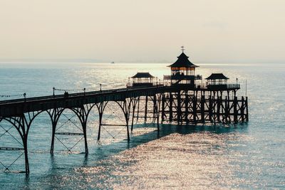 Scenic view of pier and sea against sky during sunset