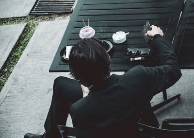 Rear view of couple sitting on staircase