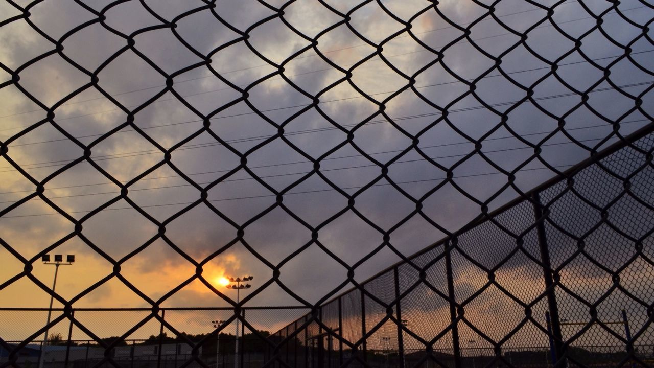 sunset, fence, chainlink fence, orange color, protection, safety, sky, metal, security, built structure, silhouette, architecture, pattern, backgrounds, no people, cloud - sky, full frame, outdoors, sunlight, building exterior