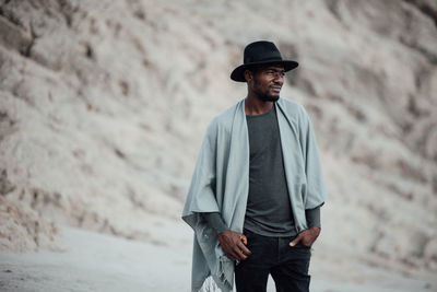 Man looking away while standing on land