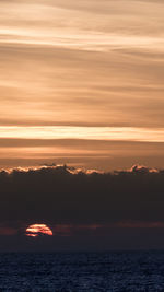 Scenic view of sea against orange sky