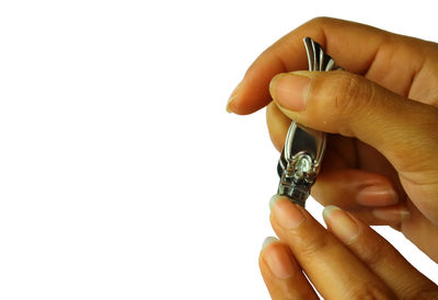 Close-up of man holding hands over white background