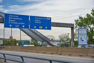 Information sign on metal against sky