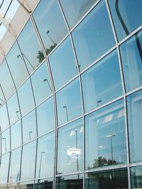 Low angle view of modern building against blue sky