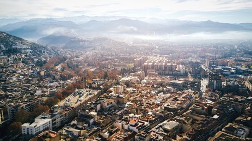 Aerial view of cityscape during foggy weather