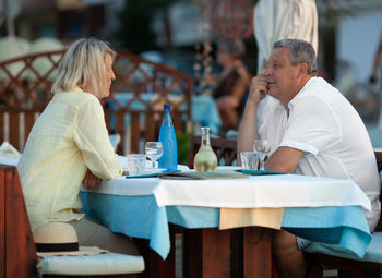 Mature couple sitting at restaurant table