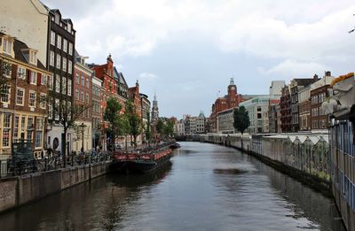 View of the canal in the center of amsterdam, yachts and old houses are visible
