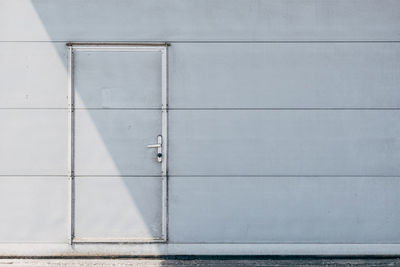 Closed metal door in metal wall